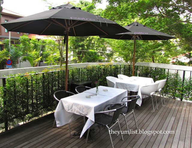 The garden courtyard is shaded by trees and freshened by a portable air cooler