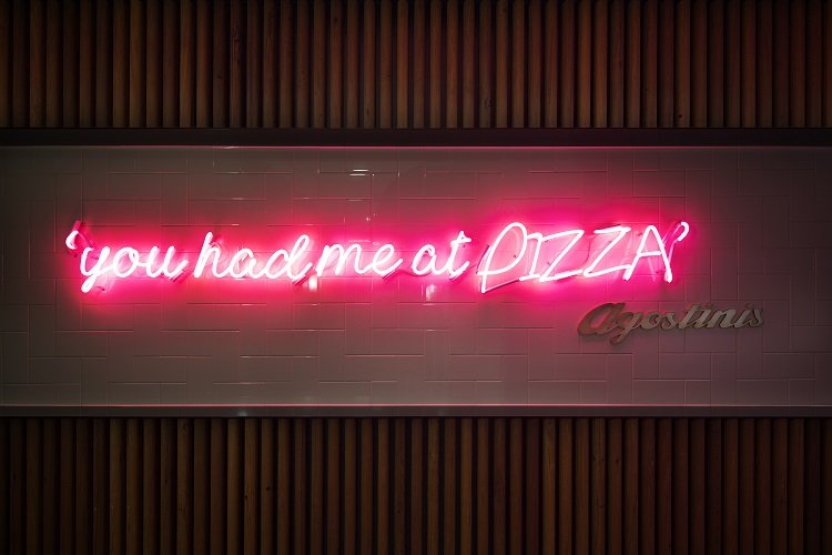 Agostini's 'You had me at pizza' neon sign in hotel lobby