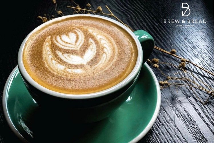 Coffee Roasters Kuala Lumpur perfectly foamed flat white in green cup