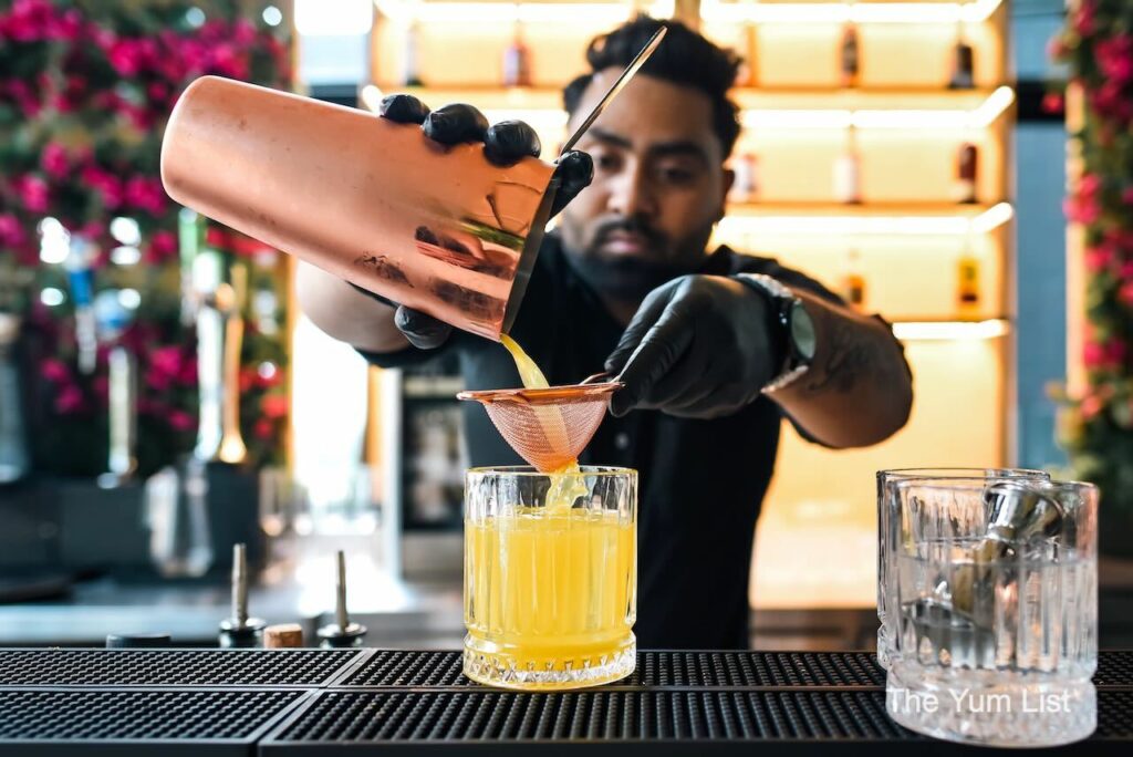 Indian Restaurant & Bar Rooftop Kuala Lumpur Bartender Ashique pouring cocktaill