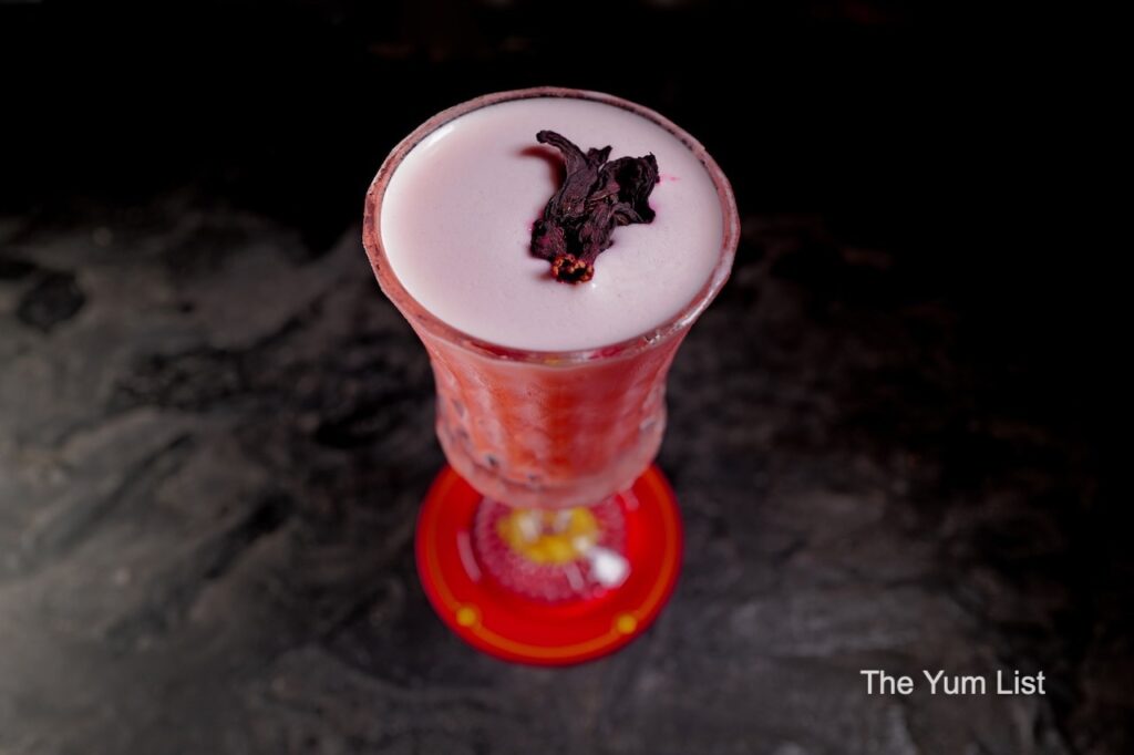 Desire Speakeasy Plaza Batai Pepper My Lips cocktail with roselle garnish