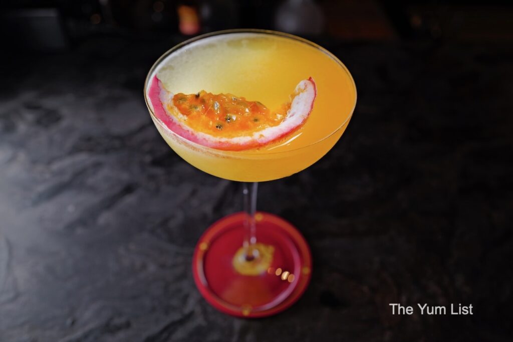 Desire Speakeasy Plaza Batai The Average Male cocktail in martini glass with passionfruit garnish