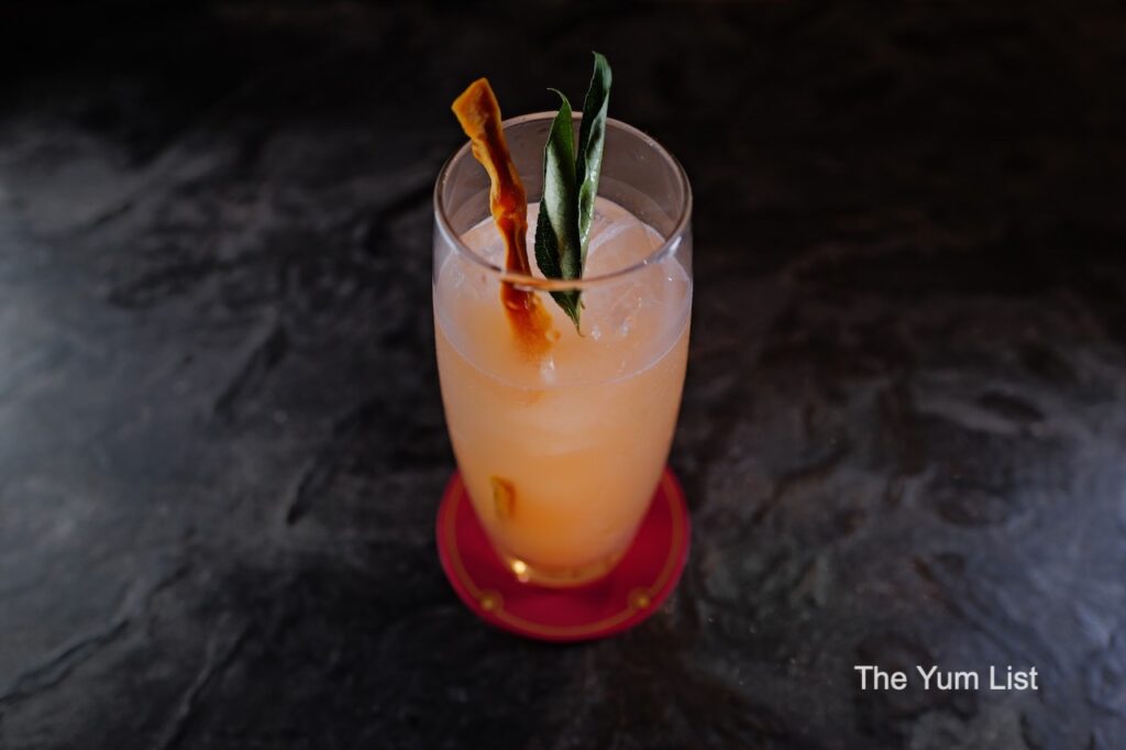 Hidden Cocktail Bar KL Jack Cur Le cocktail with jackfruit and leaf garnish