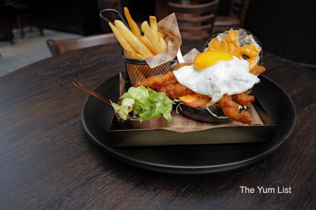 Elementary The Exchange TRX Soft Shell Crab Burger with fries and sunny-side-up egg