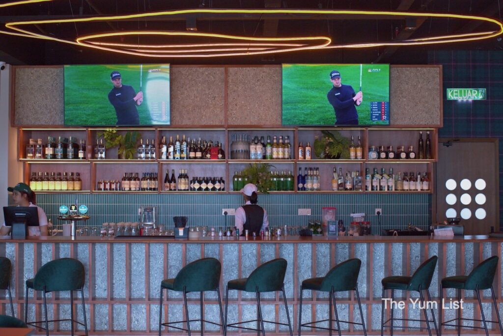 Wedge Range Golf Bar & Social Club, Petaling Jaya The Clubhouse Bar lined with green stool chairs