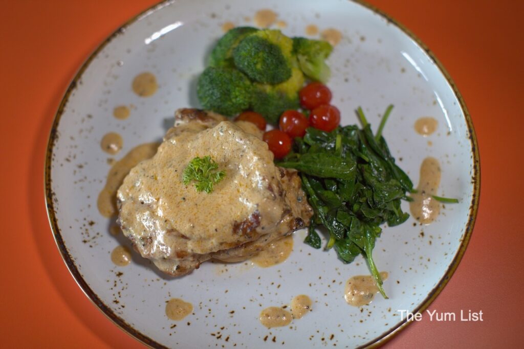 Wedge Range Golf Bar & Social Club, Petaling Jaya Creamy Coconut Tuscan Chicken with side of greens and cherry tomatoes