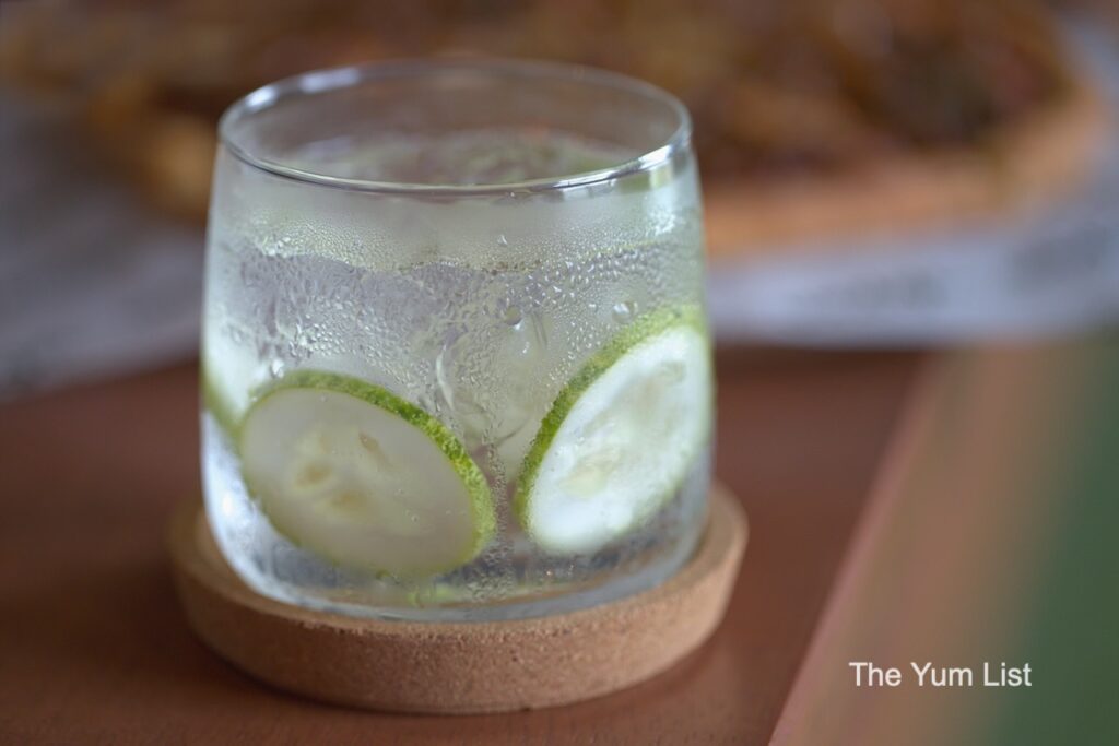 Wedge Range Golf Bar & Social Club, Petaling Jaya Tanqueray Gin & Tonic with cucumber garnish in rocks glass