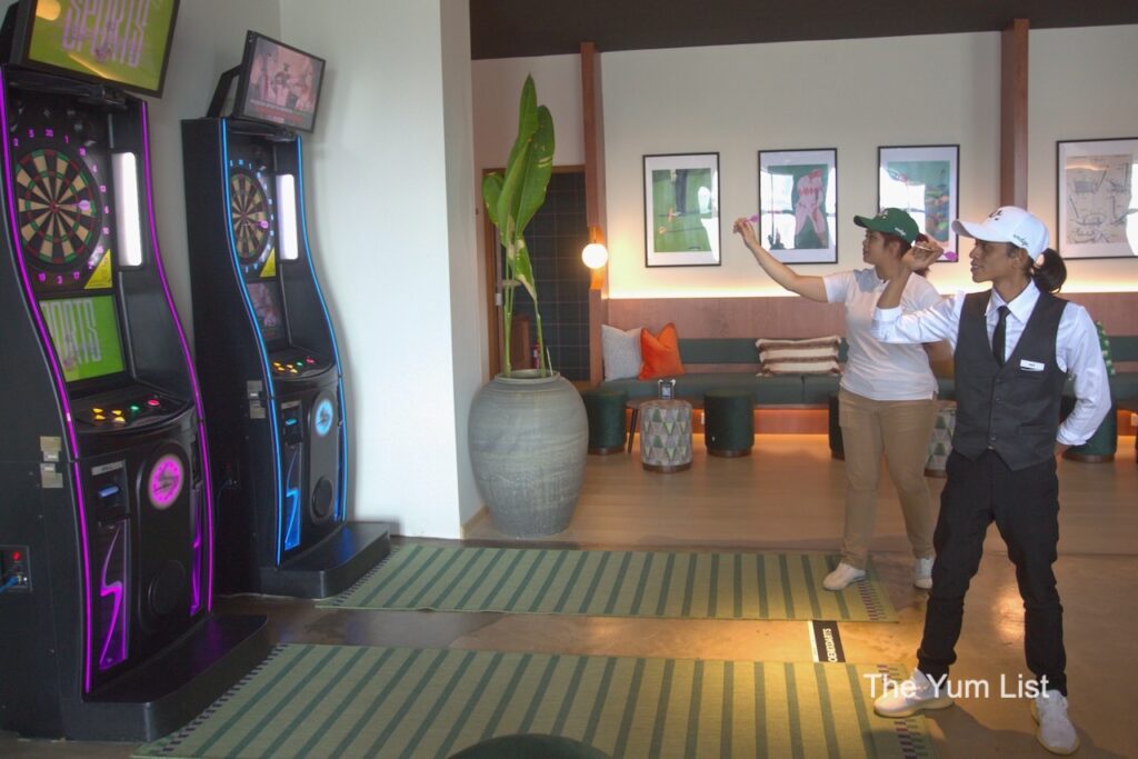 Fun things to do in KL - two people throwing darts at electronic dart board