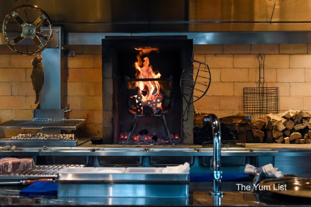 Asador V Kuala Lumpur grill on fire and wood for grill