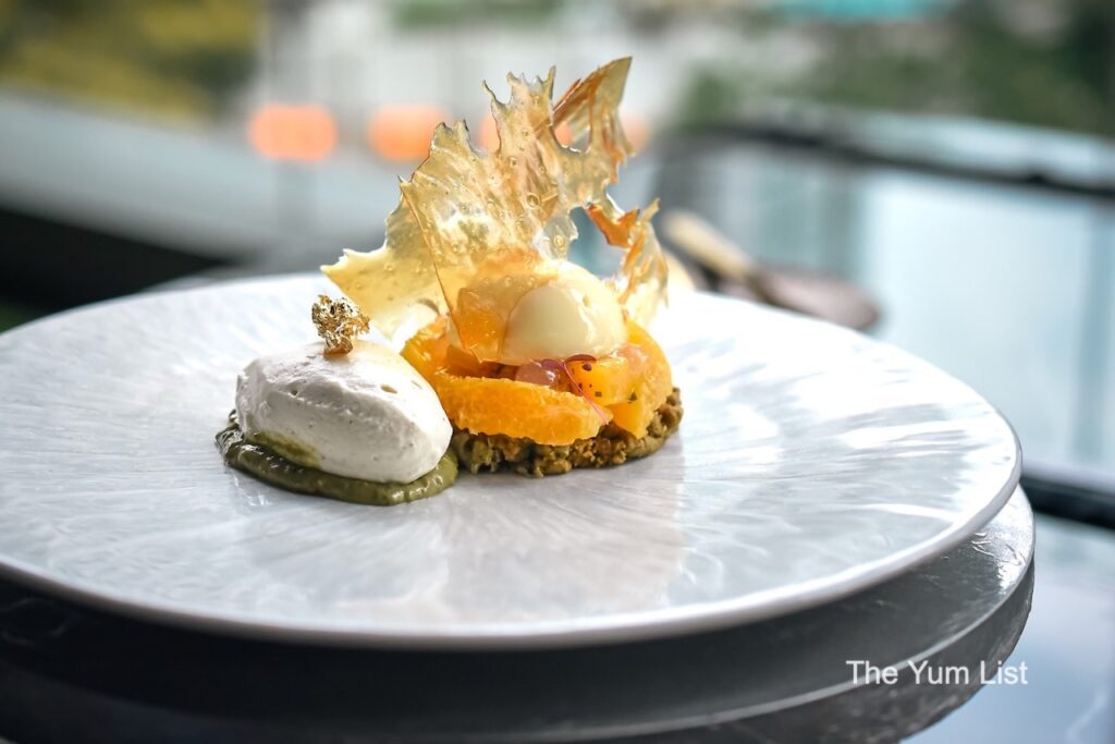 Beautiful steakhouse restaurant KL Pistachio Citrus dessert on white plate