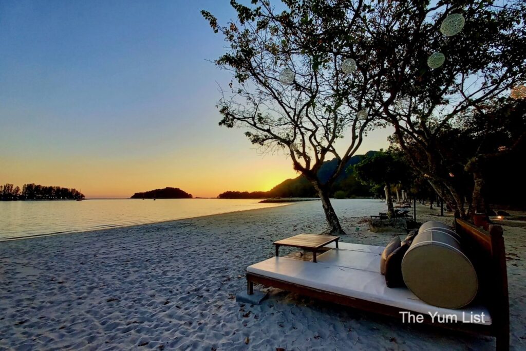 Malaysia's Top Luxury Stays daybeds on the beach at sunset