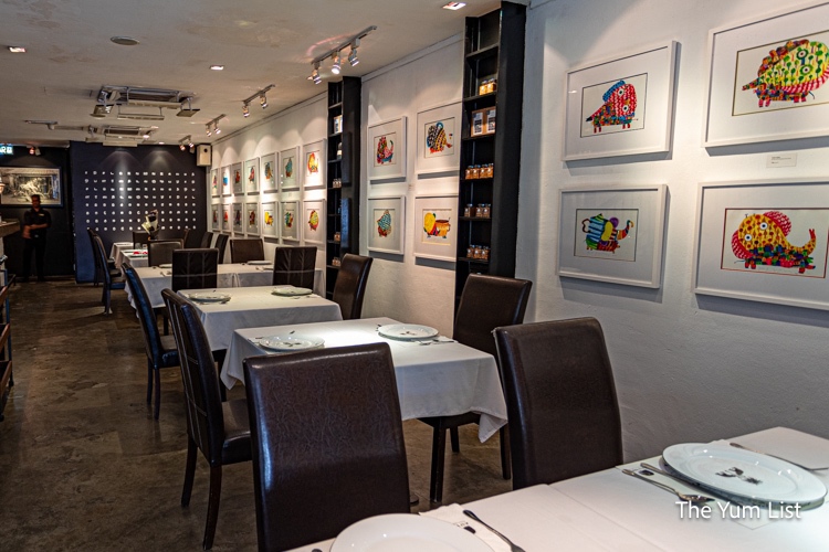Dining Room with vibrant prints on the walls