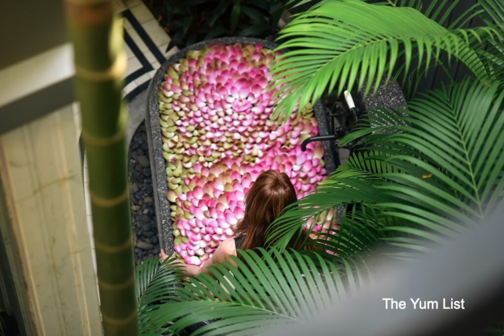 Bensley Collection Pool Villas Siem Reap outdoor bathtub covered in lotus flower petals