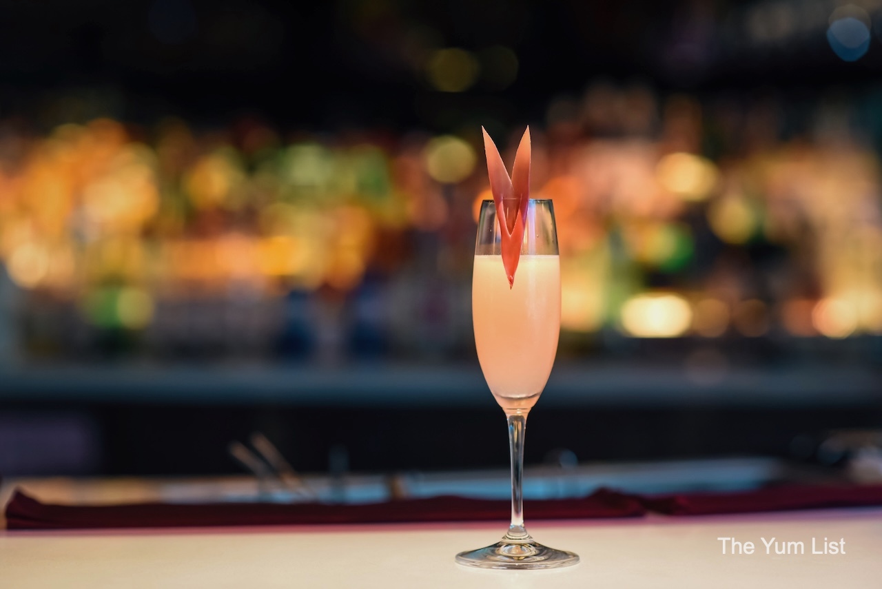 Lady Rosita Cocktail in Flute with torch ginger Avenue K Peruvian restaurant